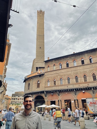 Me in front of a high medieval tower in Bologna, Italy